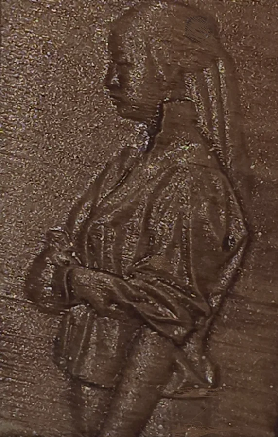 The Walnut finish on a finished Tazbear relief of a robed figure with clasped hands